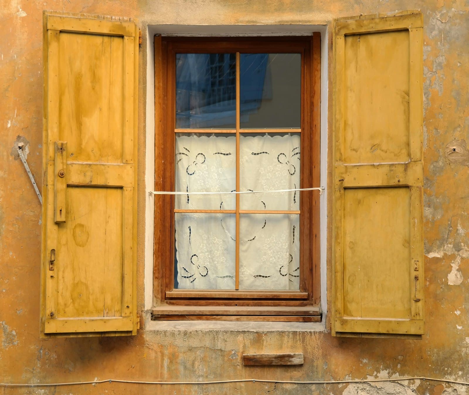 Older wooden window swung open on its hinges