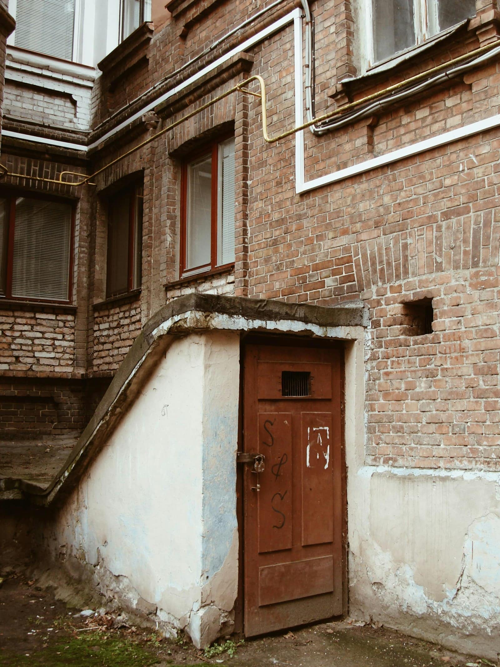 Below-grade basement entrance on a brick home
