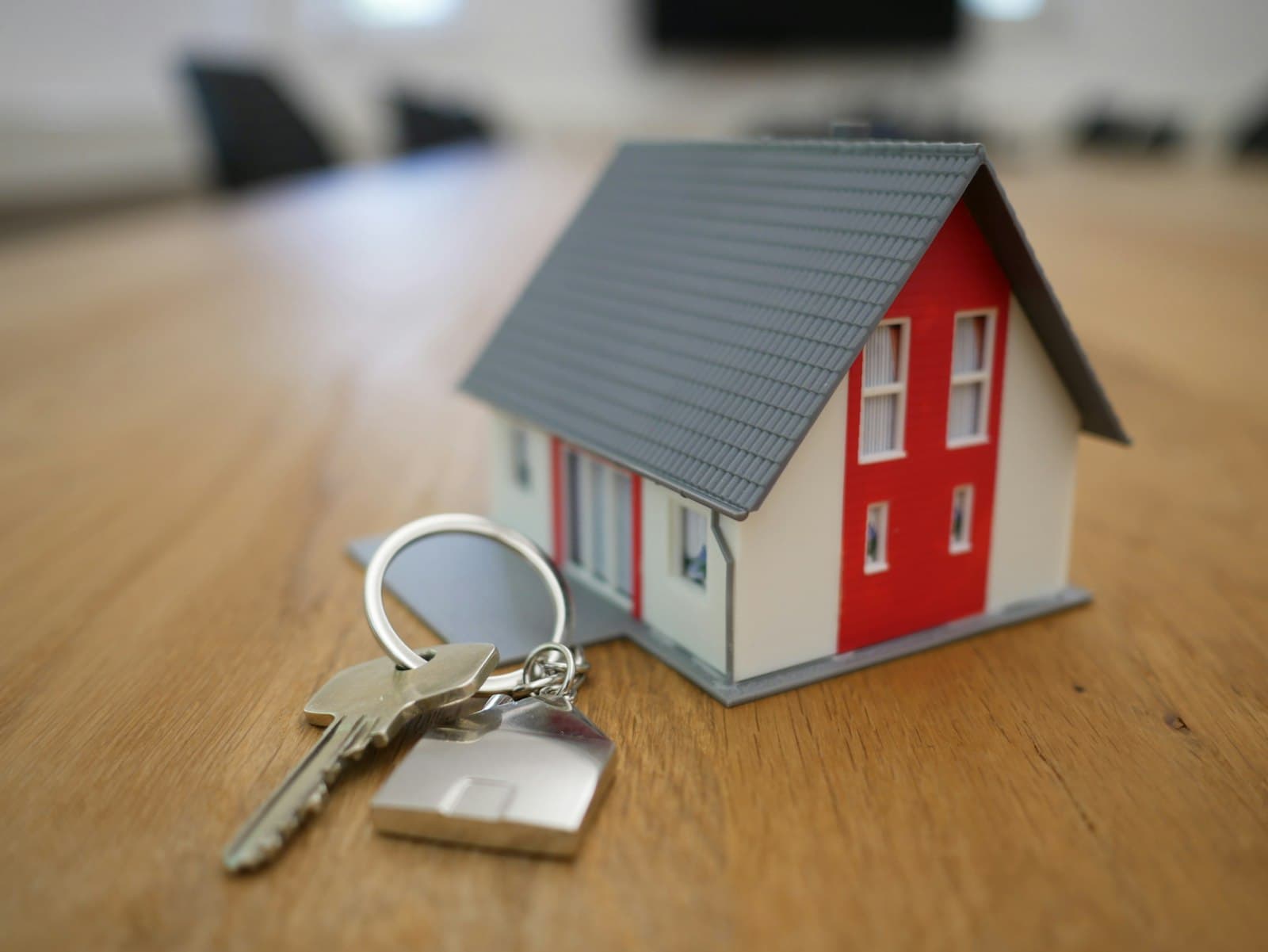 Miniature house model on a table representing home value