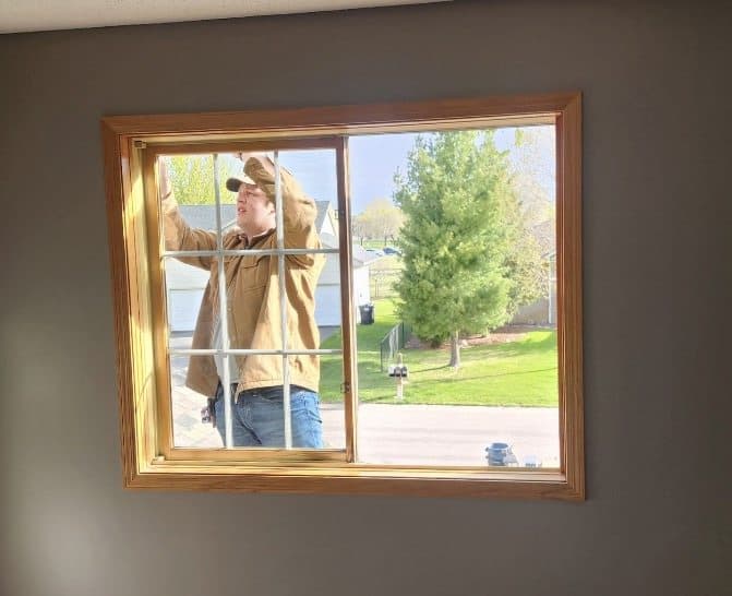 JMB Builders installer setting a new window inside a Minnesota home
