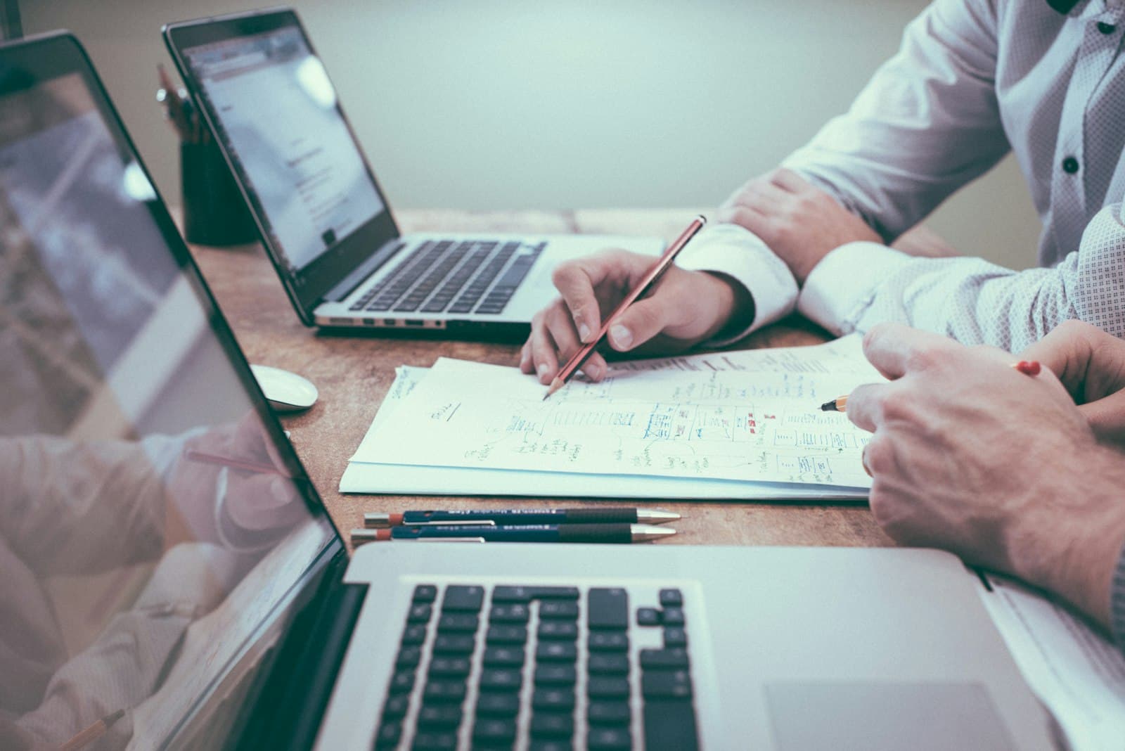 Two people reviewing a written project quote at a desk