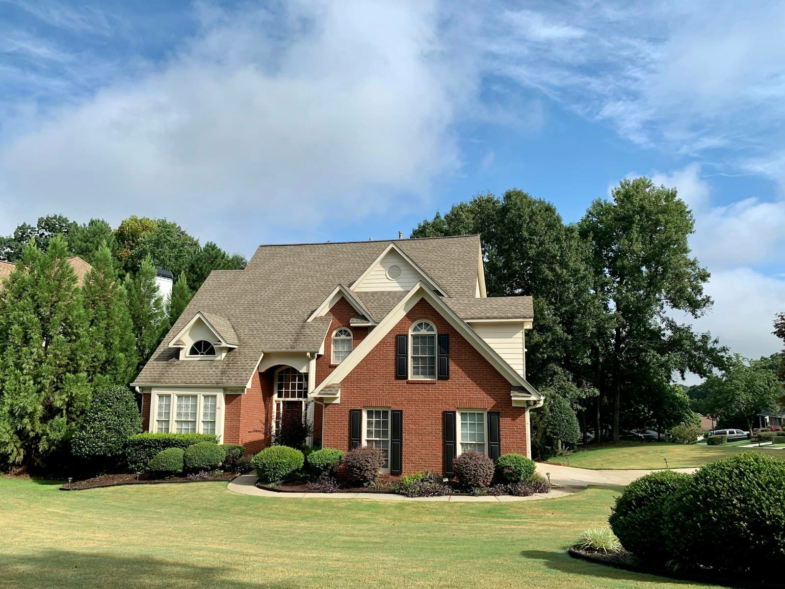 Suburban Minnesota home with trees under a blue sky