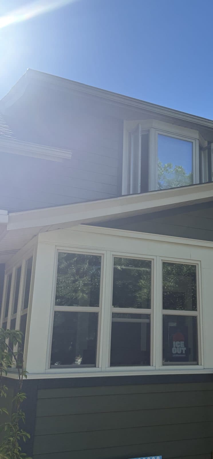 Green-sided home front with a new bay window and entry