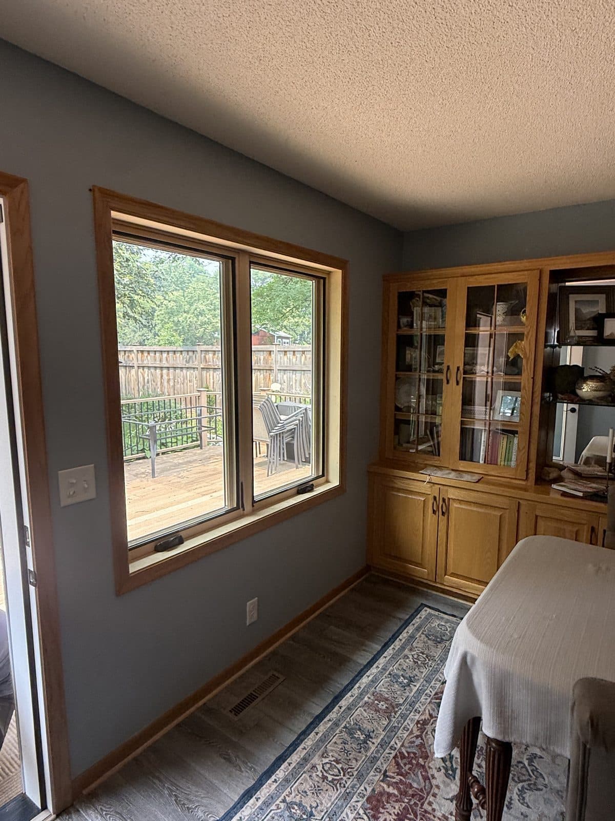 Oak-trimmed window beside a built-in hutch in a dining room
